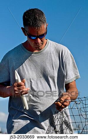 Fisherman repairing fishing trawl net, Anacortes, Washington USA. View Large Photo Image Stock Photo - Fisherman repairing fishing trawl net, Anacortes, Washington USA.. Fotosearch
