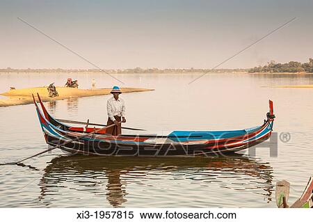 Fisherman rowing his boat on Taungthaman Lake, Amarapura, Mandalay, Myanmar, (Burma). View Large Photo Image Stock Photography - Fisherman rowing his boat on Taungthaman Lake, Amarapura, Mandalay, Myanmar, (Burma).. Fotosearch
