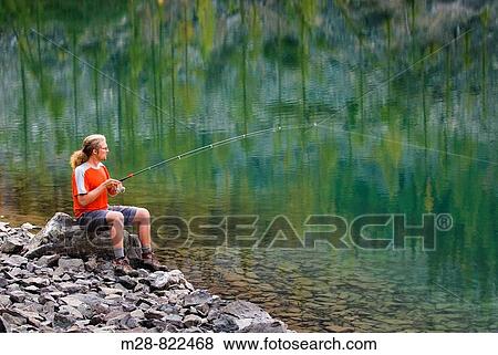 Fisherman trying his luck at Copper Glance Lake, Okanogan National Forest Wasington USA View Large Photo Image Stock Photo - Fisherman trying his luck at Copper Glance Lake, Okanogan National Forest Wasington USA. Fotosearch