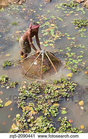 Fisherman with fishing net at Bhuvaneshwar, Odisha, India View Large Photo Image Stock Image - Fisherman with fishing net at Bhuvaneshwar, Odisha, India. Fotosearch