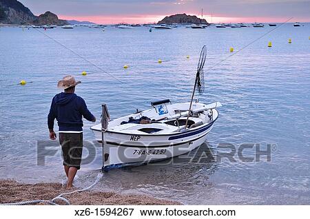 Fisherman with his boat at sunrise View Large Photo Image Stock Photo - Fisherman with his boat at sunrise. Fotosearch