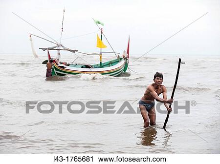 Stock Image - fisherman working in the sea of java, indonesia. Fotosearch
