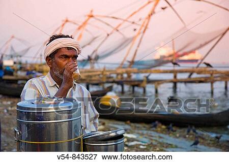 Stock Photo - Fishermen and traditional fishing nets, Fort Cochin, Kerala. Fotosearch