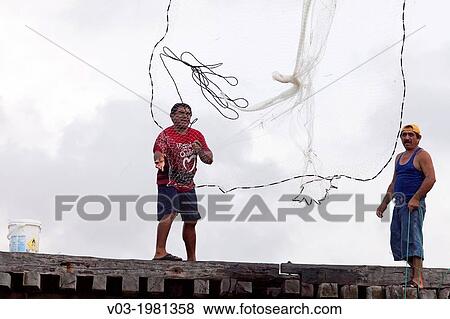 Fishermen fishing on a bridge; Rio Lagartos Natural Park: A place to watch wildlife and flamingos, Yucatan, Mexico. View Large Photo Image Stock Photo - Fishermen fishing on a bridge; Rio Lagartos Natural Park: A place to watch wildlife and flamingos, Yucatan, Mexico.. Fotosearch