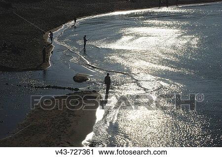 Stock Image - Fishermen on a beach near l? Escala. Girona province. Catalonia. Spain. Fotosearch