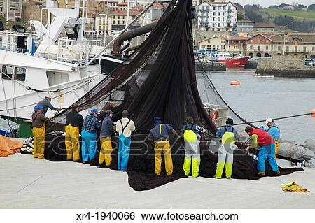 Fishermen working on the port of Getaria, Getaria, Guetaria, Gipuzkoa, Guipuzcoa, Pais Vasco, Spain View Large Photo Image Stock Photograph - Fishermen working on the port of Getaria, Getaria, Guetaria, Gipuzkoa, Guipuzcoa, Pais Vasco, Spain. Fotosearch
