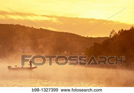 Fishing at dawn in the Table Rock lake at Big Cedar Lodge, Missouri. View Large Photo Image Stock Photo - Fishing at dawn in the Table Rock lake at Big Cedar Lodge, Missouri.. Fotosearch
