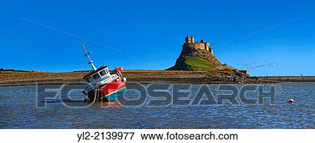 Fishing boat and 16th Century castle of Holy Island, Lindisfarne, Northumberland, England. View Large Photo Image Stock Photo - Fishing boat and 16th Century castle of Holy Island, Lindisfarne, Northumberland, England.. Fotosearch