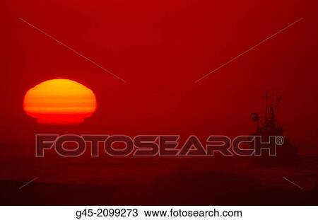 Stock Image - Fishing boat at dusk in Finisterre, Galicia.. Fotosearch