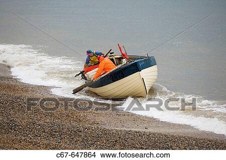 Fishing Boat landing catch at Weybourne Norfolk View Large Photo Image Picture - Fishing Boat landing catch at Weybourne Norfolk. Fotosearch