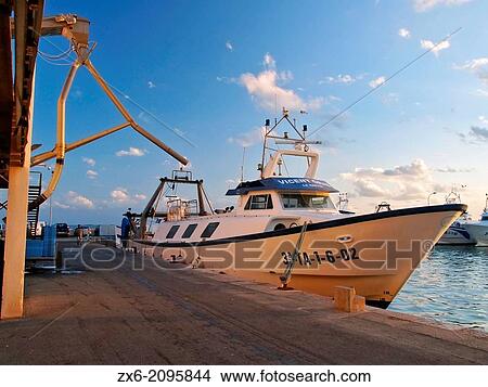 Fishing boat moored at the Fishing Market building dock. Sant Carles de la Rapita port. Montsia Region, Tarragona Province, Catalonia, Spain. View Large Photo Image Picture - Fishing boat moored at the Fishing Market building dock. Sant Carles de la Rapita port. Montsia Region, Tarragona Province, Catalonia, Spain.. Fotosearch