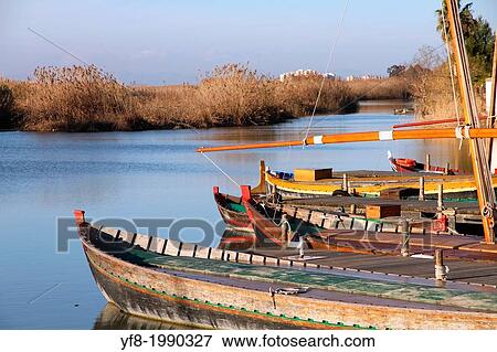 Fishing boats in La Albufera nature reserve, El Palmar, Valencia, Comunidad Valenciana, Spain. View Large Photo Image Stock Photo - Fishing boats in La Albufera nature reserve, El Palmar, Valencia, Comunidad Valenciana, Spain.. Fotosearch