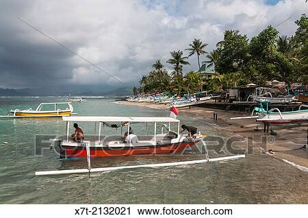 Fishing boats on the beach at Candi Dasa, Eastern Bali, Indonesia. View Large Photo Image Stock Image - Fishing boats on the beach at Candi Dasa, Eastern Bali, Indonesia.. Fotosearch
