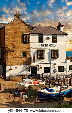 Fishing boats & the Bay Hotel of historic fishing village of Robin Hood's Bay, Near Whitby, North Yorkshire, England View Large Photo Image Stock Image - Fishing boats & the Bay Hotel of historic fishing village of Robin Hood's Bay, Near Whitby, North Yorkshire, England. Fotosearch