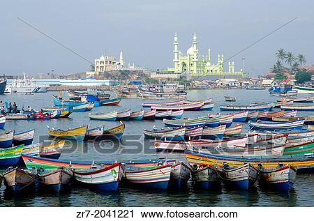 Stock Image - Fishing boats with Vizhinjam mosque in the background, Kerala, South India.. Fotosearch