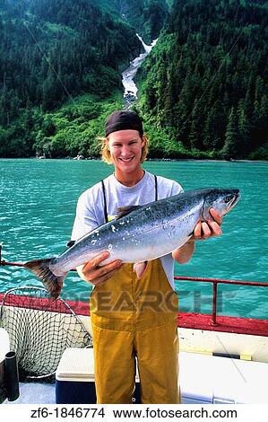 Fishing Charter Teenager Cleaning Fish in Valdez Alaska USA View Large Photo Image Picture - Fishing Charter Teenager Cleaning Fish in Valdez Alaska USA. Fotosearch