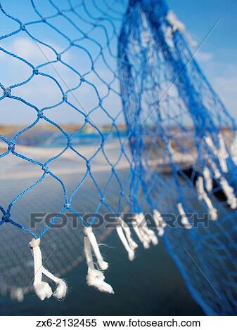 Fishing net detail at La Tancada Lagoon drainage channel. Ebro River Delta Natural Park, Tarragona province, Catalonia, Spain. View Large Photo Image Stock Photography - Fishing net detail at La Tancada Lagoon drainage channel. Ebro River Delta Natural Park, Tarragona province, Catalonia, Spain.. Fotosearch