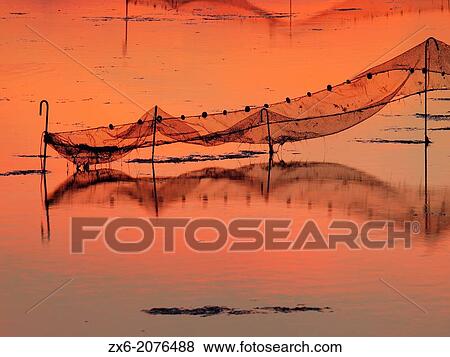Fishing nets at Fangar Bay after sunset. Ebro River Delta Natural Park, Tarragona province, Catalonia, Spain. View Large Photo Image Stock Photo - Fishing nets at Fangar Bay after sunset. Ebro River Delta Natural Park, Tarragona province, Catalonia, Spain.. Fotosearch