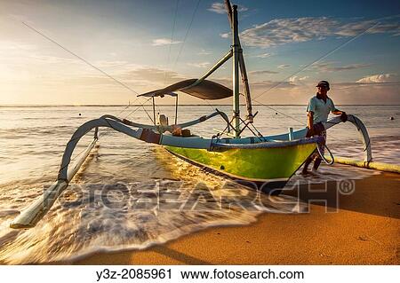 Fishing vessel with outriggers on beach at dawn, Sanur, Bali, Indonesia. View Large Photo Image Stock Image - Fishing vessel with outriggers on beach at dawn, Sanur, Bali, Indonesia.. Fotosearch