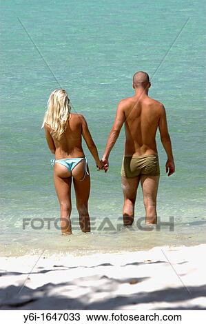 Fit couple cool off in water tropical white sand beach Ao Lo Dalam Phi Phi Island Thailand View Large Photo Image Stock Image - Fit couple cool off in water tropical white sand beach Ao Lo Dalam Phi Phi Island Thailand. Fotosearch