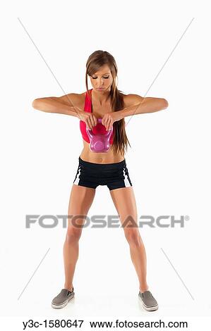 Fitness woman exercising with kettlebell View Large Photo Image Stock Photo - Fitness woman exercising with kettlebell. Fotosearch