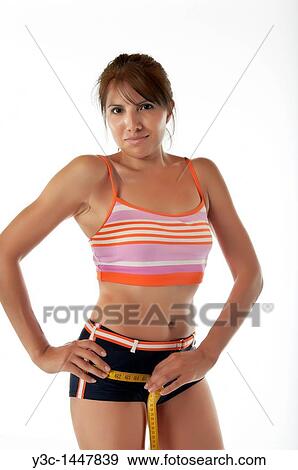 Fitness woman measuring hips with tape measure View Large Photo Image Stock Photo - Fitness woman measuring hips with tape measure. Fotosearch