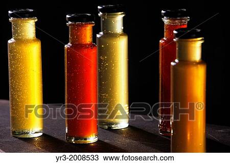 Stock Image - Five honey jars are displayed in Puremiel, a honey company that produces organic raw honey, Cadiz, Andalusia, Spain, July 1, 2013.. Fotosearch