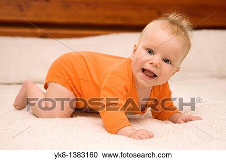 Five month old baby crawling on bed View Large Photo Image Stock Image - Five month old baby crawling on bed. Fotosearch