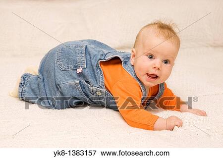 Five month old baby crawling on bed View Large Photo Image Stock Photo - Five month old baby crawling on bed. Fotosearch