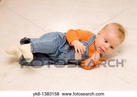 Five month old baby on bed View Large Photo Image Stock Photo - Five month old baby on bed. Fotosearch