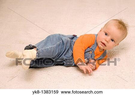 Five month old baby on bed View Large Photo Image Stock Photo - Five month old baby on bed. Fotosearch