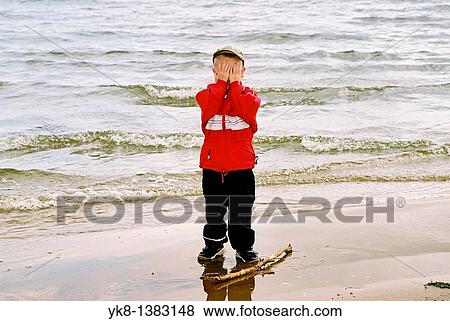 Five Year Old Boy Hiding Face with Hands by Water View Large Photo Image Stock Photo - Five Year Old Boy Hiding Face with Hands by Water. Fotosearch