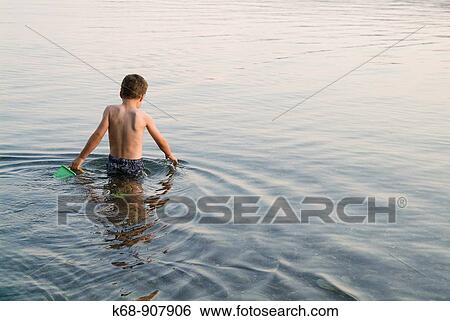 Stock Photograph - five year old boy in water at Porpoise Bay, BC, Canada. Fotosearch