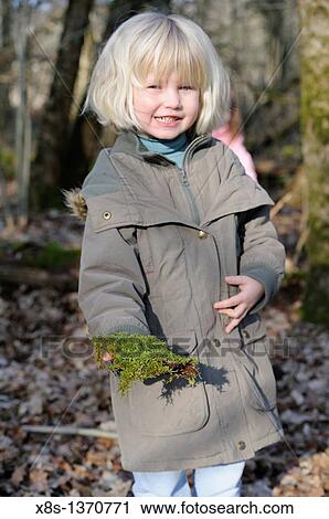 Five year old girl showing a piece of moss she has found on a nature walk View Large Photo Image Stock Image - Five year old girl showing a piece of moss she has found on a nature walk. Fotosearch