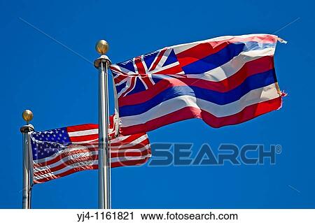 Stock Image - flags of the United States of America and the State of Hawaii at the entrance of Puukohola Heiau National Historic Site, Kawaihae, Kohala, Big Island, Hawaii, USA. Fotosearch