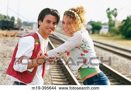 Picture - flambouyant couple on RxR tracks. Fotosearch