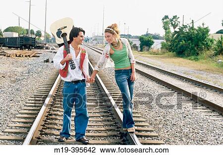 flambouyant couple on RxR tracks View Large Photo Image Stock Image - flambouyant couple on RxR tracks. Fotosearch