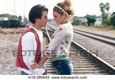 Stock Image - flambouyant couple on RxR tracks. Fotosearch
