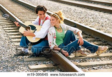 flambouyant couple on RxR tracks View Large Photo Image Stock Photography - flambouyant couple on RxR tracks. Fotosearch