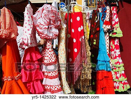 Flamenco dresses on market stall on famous street market in calle Ferria, in Barrio Macarena, Seville, Spain, Europe View Large Photo Image Stock Image - Flamenco dresses on market stall on famous street market in calle Ferria, in Barrio Macarena, Seville, Spain, Europe. Fotosearch