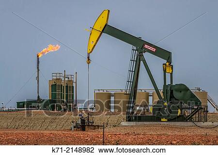 Flaring natural gas at a Bakkan play oil pumper installation near Williston, North Dakota, USA. View Large Photo Image Stock Image - Flaring natural gas at a Bakkan play oil pumper installation near Williston, North Dakota, USA.. Fotosearch