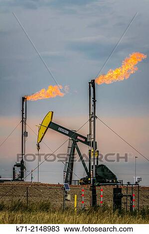 Flaring natural gas at a Bakkan play oil pumper installation near Williston, North Dakota, USA. View Large Photo Image Stock Image - Flaring natural gas at a Bakkan play oil pumper installation near Williston, North Dakota, USA.. Fotosearch