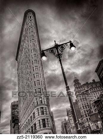 Stock Image - Flat iron building with street light.. Fotosearch