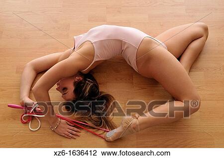 flexible young woman exercising, gymnastics, with a rope on the floor View Large Photo Image Stock Image - flexible young woman exercising, gymnastics, with a rope on the floor. Fotosearch