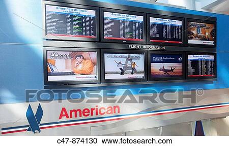 Stock Image - Flight information, American Airlines terminal, JFK airport, New York, USA. Fotosearch