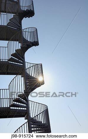 Picture - Flight of winding stairs against sun at backlight, lensflare Bavaria, Germany, Europe. Fotosearch