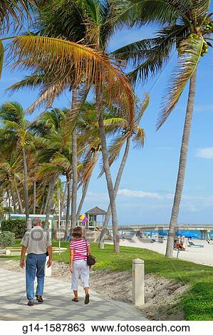Florida, Deerfield Beach, Ocean Way, palm trees, sand, public, Atlantic Ocean, coast, shore, surf, sunbathers, Deerfield Beach International Fishing Pier, couple, man, woman, walking, View Large Photo Image Stock Image - Florida, Deerfield Beach, Ocean Way, palm trees, sand, public, Atlantic Ocean, coast, shore, surf, sunbathers, Deerfield Beach International Fishing Pier, couple, man, woman, walking,. Fotosearch