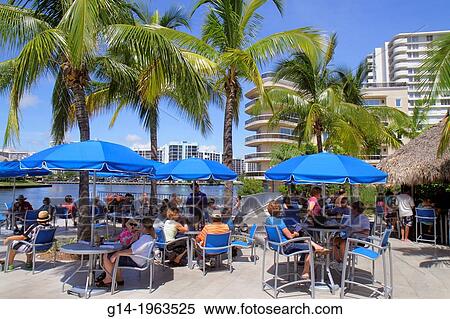 Stock Photography - Florida, Hollywood, Intracoastal Waterway, condominium, buildings, water, Crowne Plaza Hollywood Beach, hotel, man, woman, couple, tables, Lava Tiki Bar & Grill, restaurant, alfresco, dining,.. Fotosearch