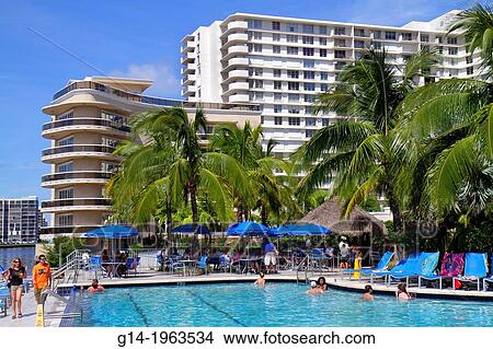 Florida, Hollywood, water, Crowne Plaza Hollywood Beach, hotel, swimming pool area, woman, palm trees, condominium buildings,. View Large Photo Image Picture - Florida, Hollywood, water, Crowne Plaza Hollywood Beach, hotel, swimming pool area, woman, palm trees, condominium buildings,.. Fotosearch