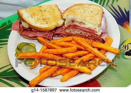 Stock Photo - Florida, Juno Beach, Juno Beach Cafe, restaurant, interior, Reuben sandwich, sweet potato fries, plate, food,. Fotosearch